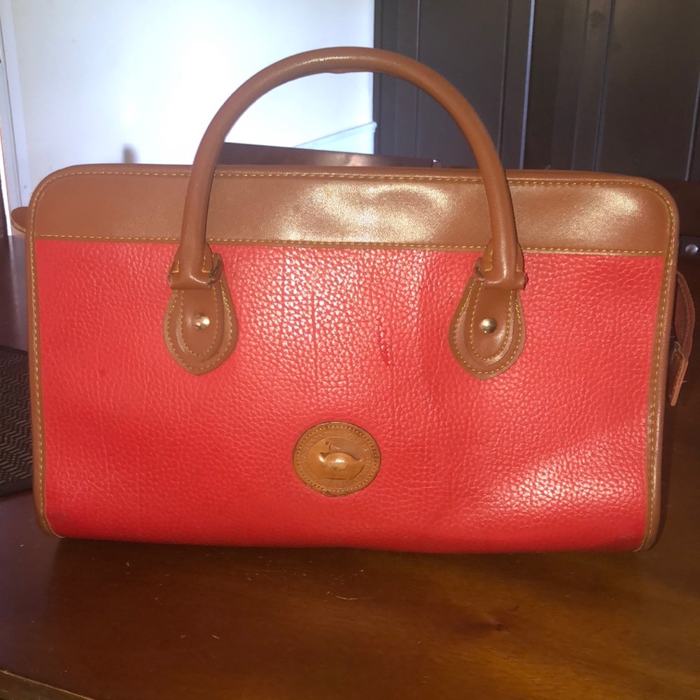 Great condition Dooney & Bourke! It has 3 different compartments.